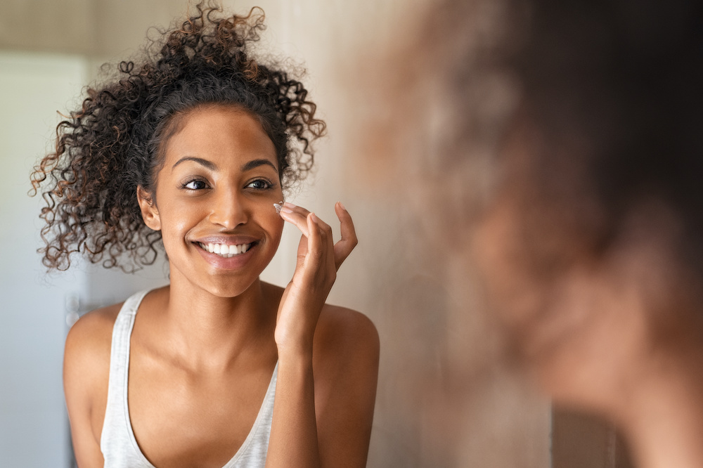 beautiful young woman looking in the mirror